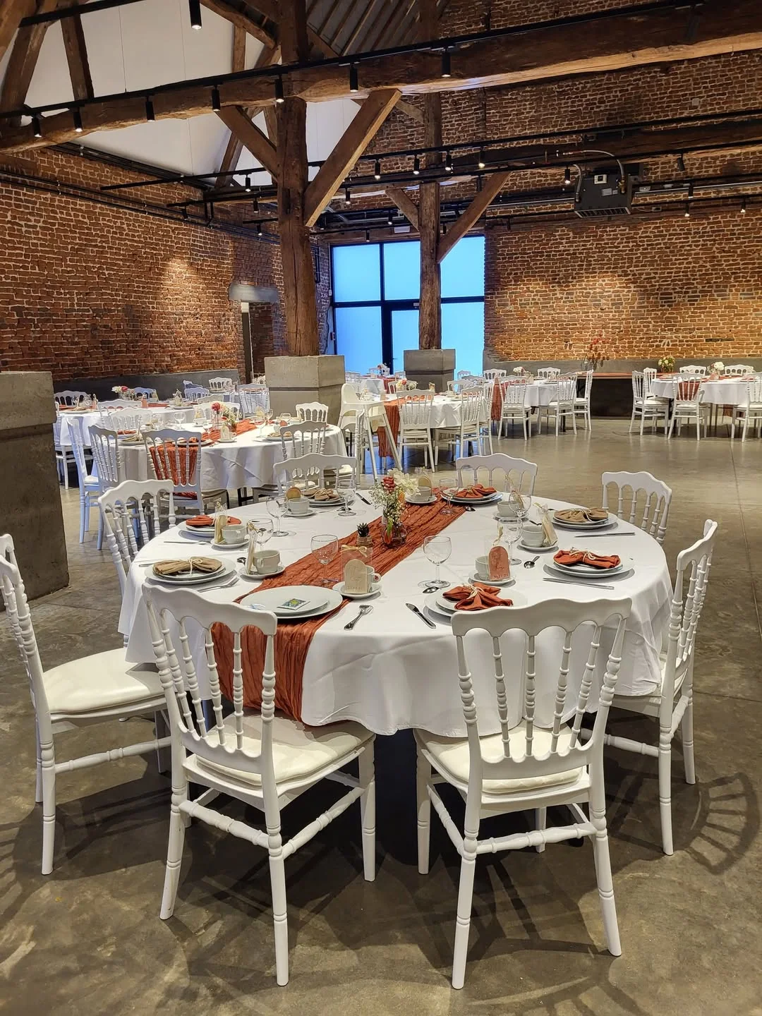Salle de réception La Grange des Jonquilles à La Louvière, intérieur avec poutres apparentes et tables dressées